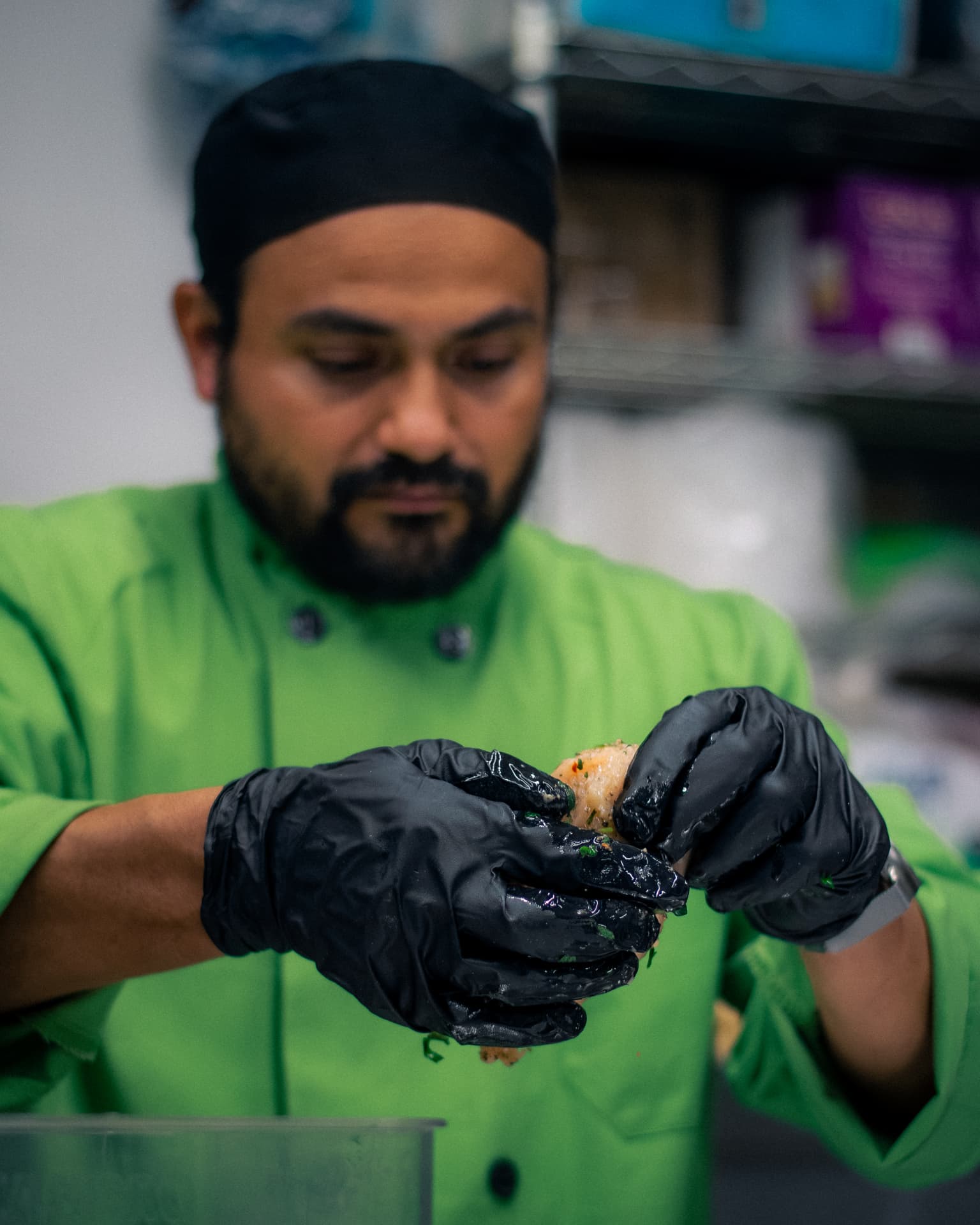 Chef Pacheco forming tamale masa by hand in the kitchen